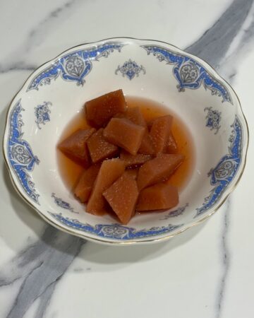 vintage blue and white bowl filled with slow cooked quinces