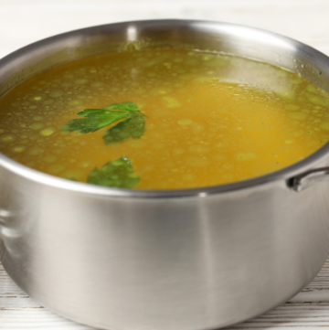 silver pot filled with homemade vegetable broth