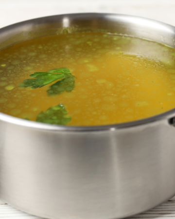 silver pot filled with homemade vegetable broth