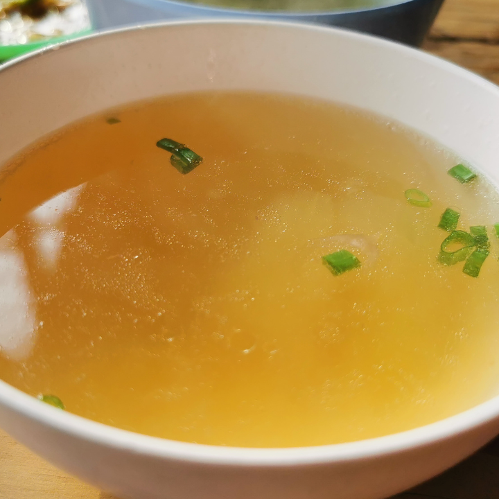 white soup bowl filled with clear broth