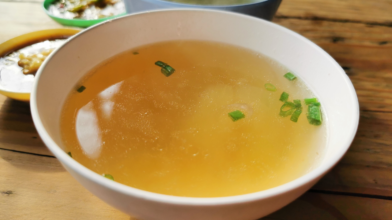 white soup bowl filled with clear broth