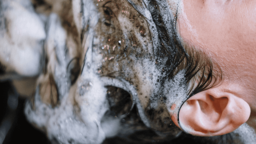 Close up shot of woman's shampooed head