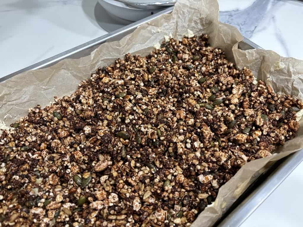 Silver baking tray filled with baked granola