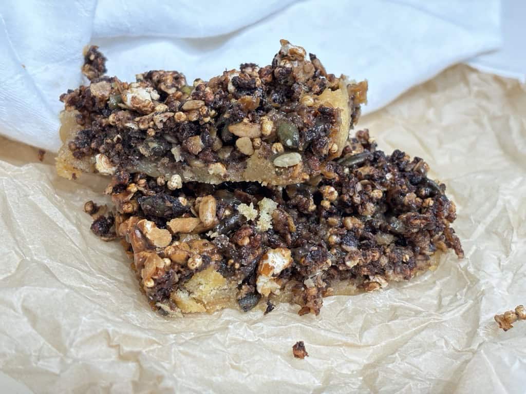 Two sweet and salty granola bars on parchment paper