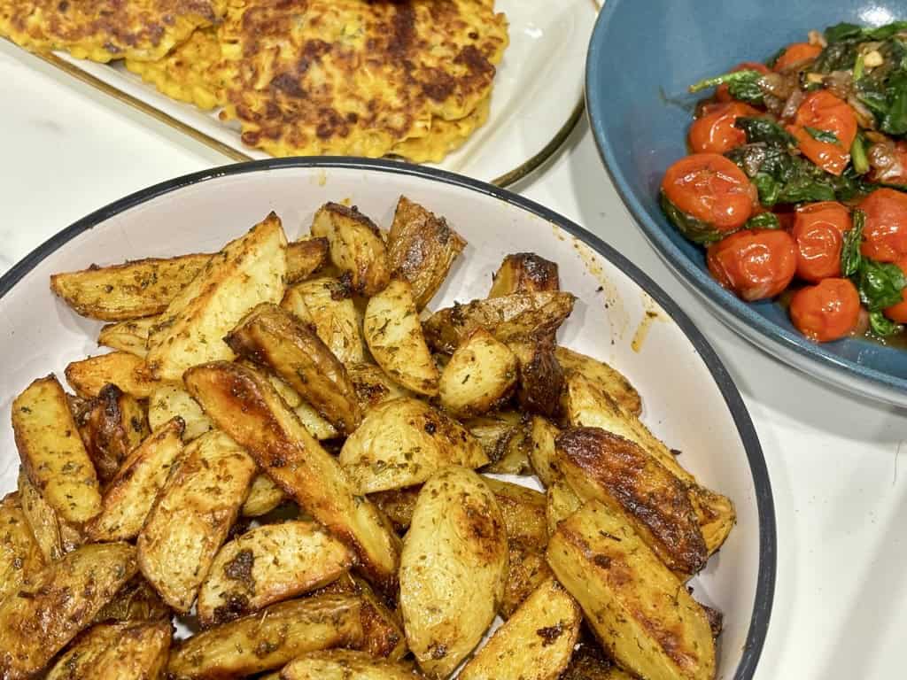 Bowl of Buffalo Wild Wings Potato Wedges in front of other food