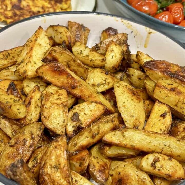 Bowl of Buffalo Wild Wings Potato Wedges in front of other food