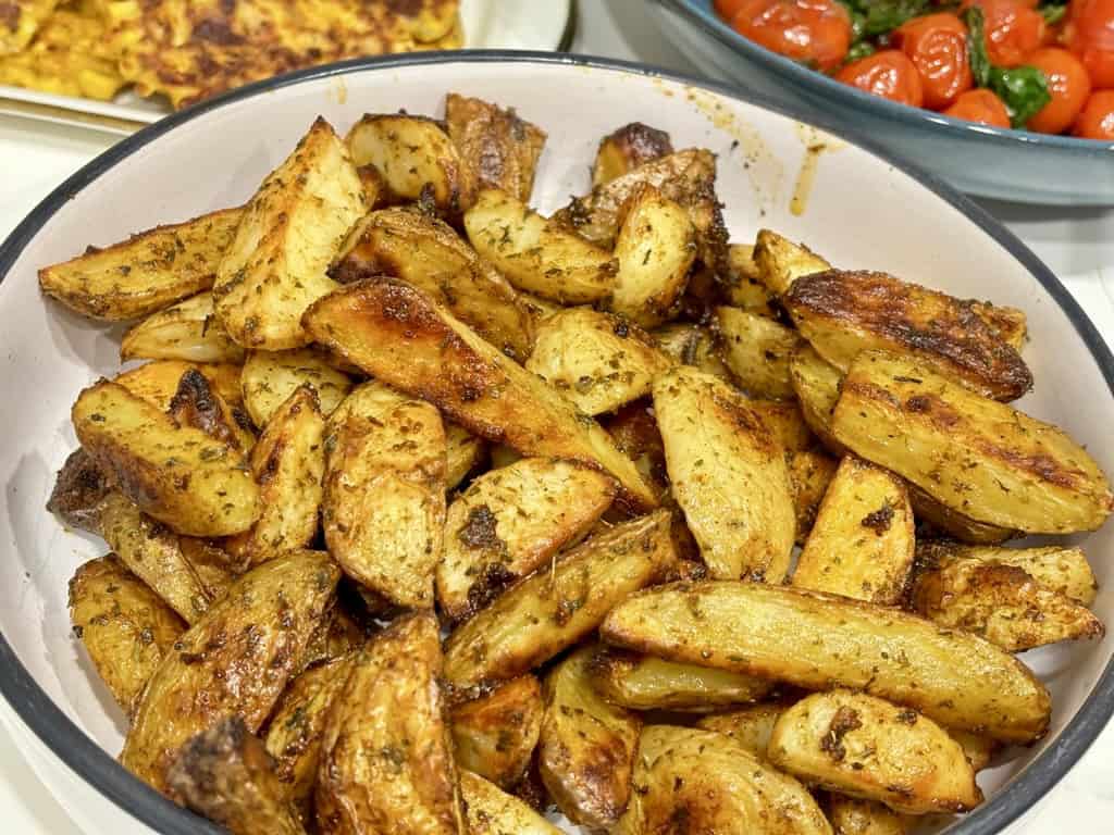 Bowl of Buffalo Wild Wings Potato Wedges in front of other food