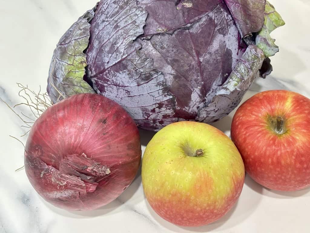 head of red cabbage, two red apples and one red onion