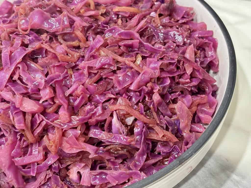 Braised red cabbage and apple in white serving bowl