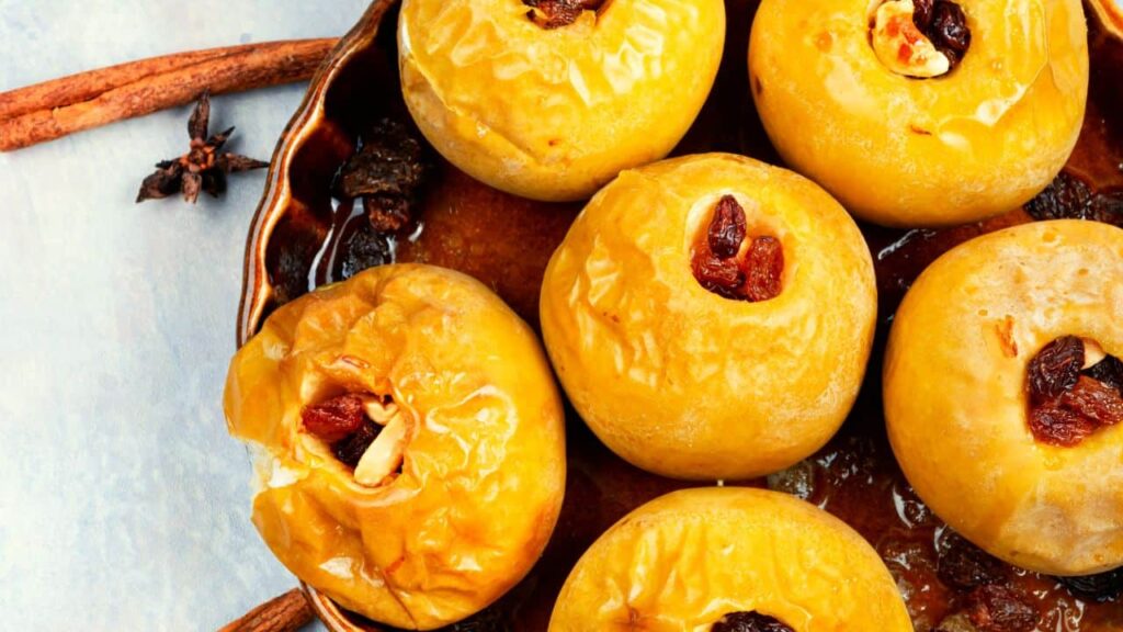 Close up shot of baked stuffed apples in brown serving tray