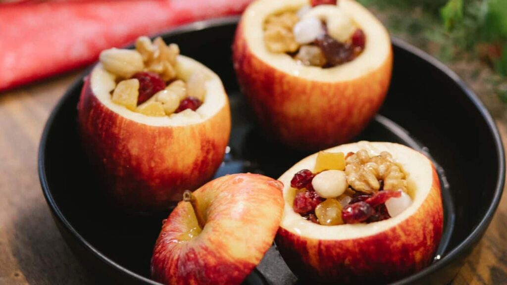 Three stuffed apples in black bowl