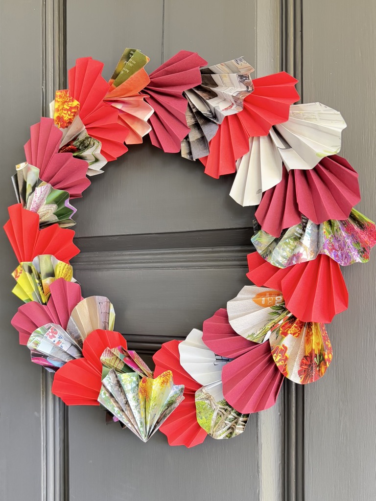 red paper heart wreath on grey door