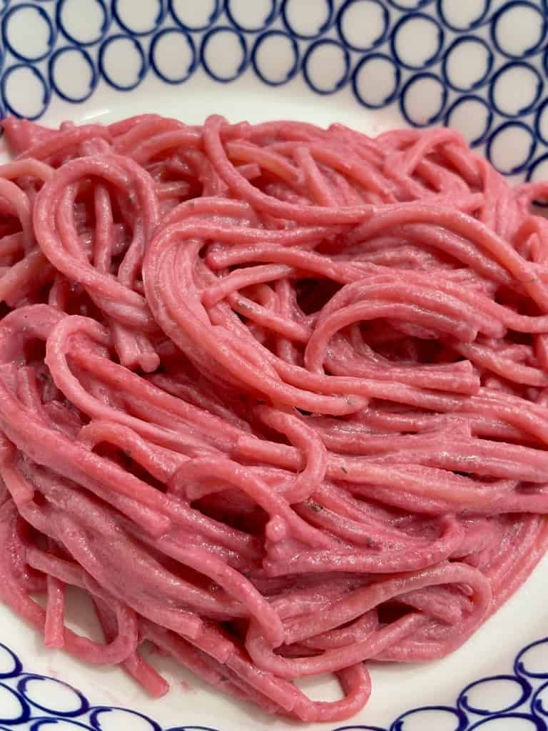 Close up shot of pink spaghetti in bowl