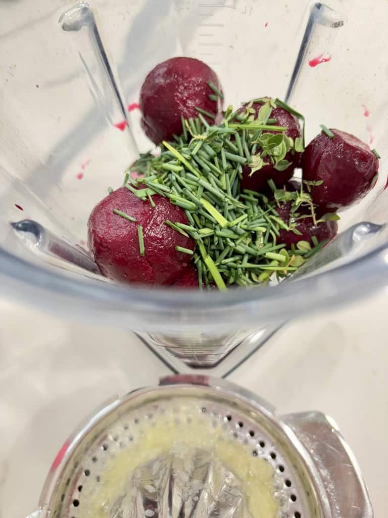 Beetroot and herbs in large blender