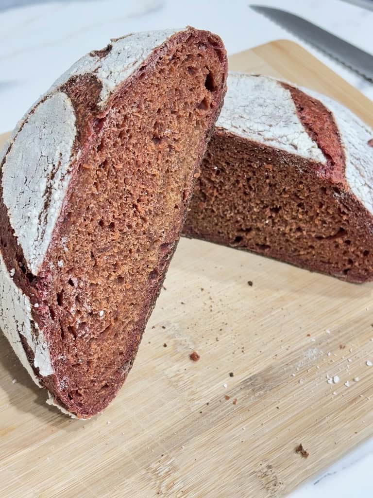 Two pink loaf halves on wooden board