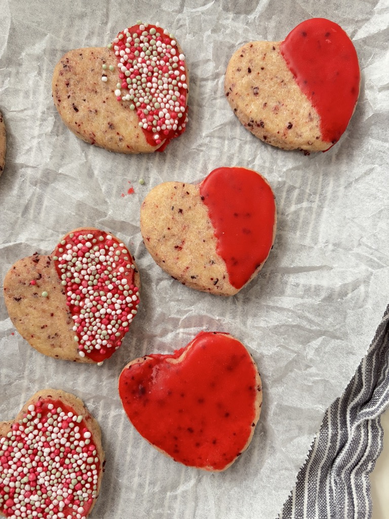 Red heart shaped cookies on parchment paper