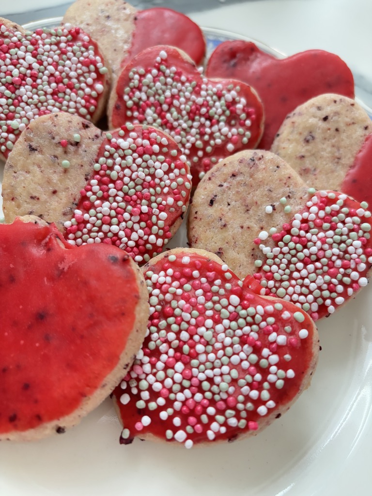 Plate with red iced, heart cookies