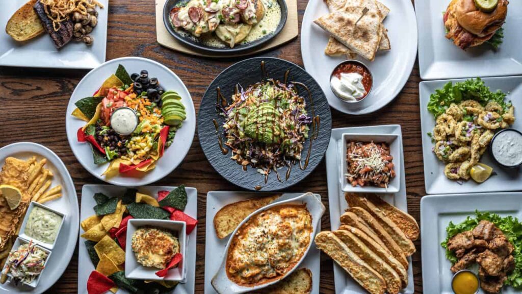 Top down shot of dinner table set with variety of dishes