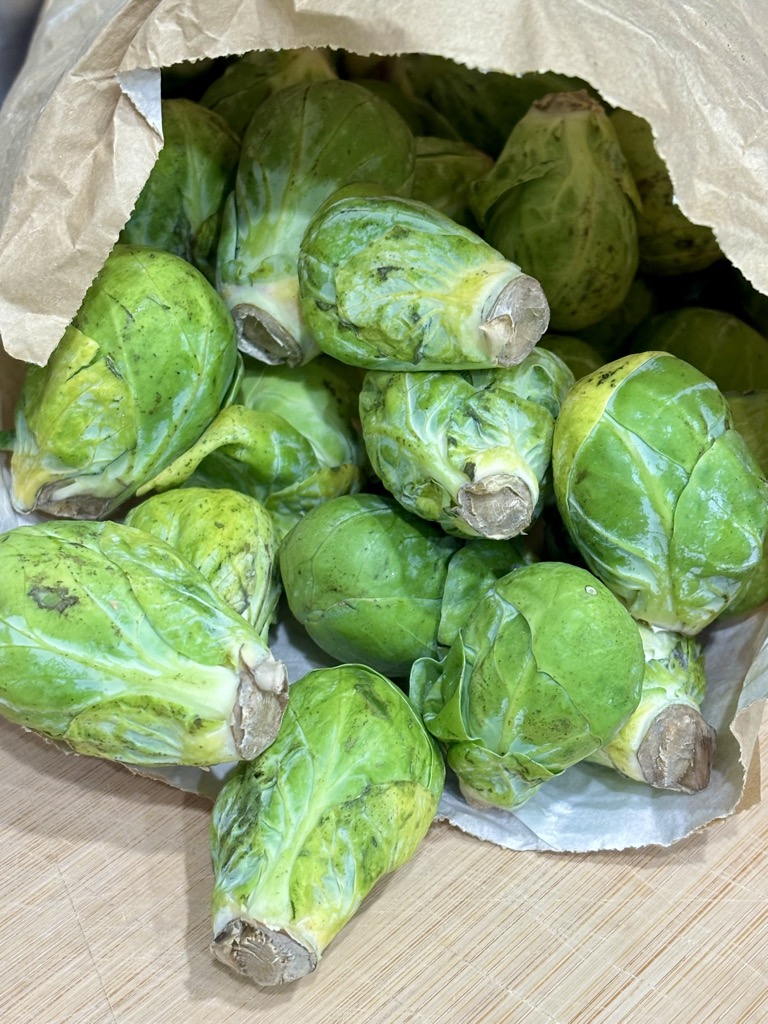 Paper bag filled with brussel sprouts