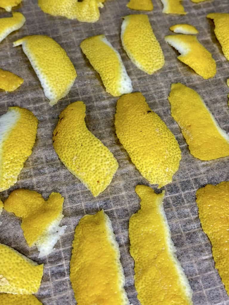 Lemon peels laid out on parchment paper