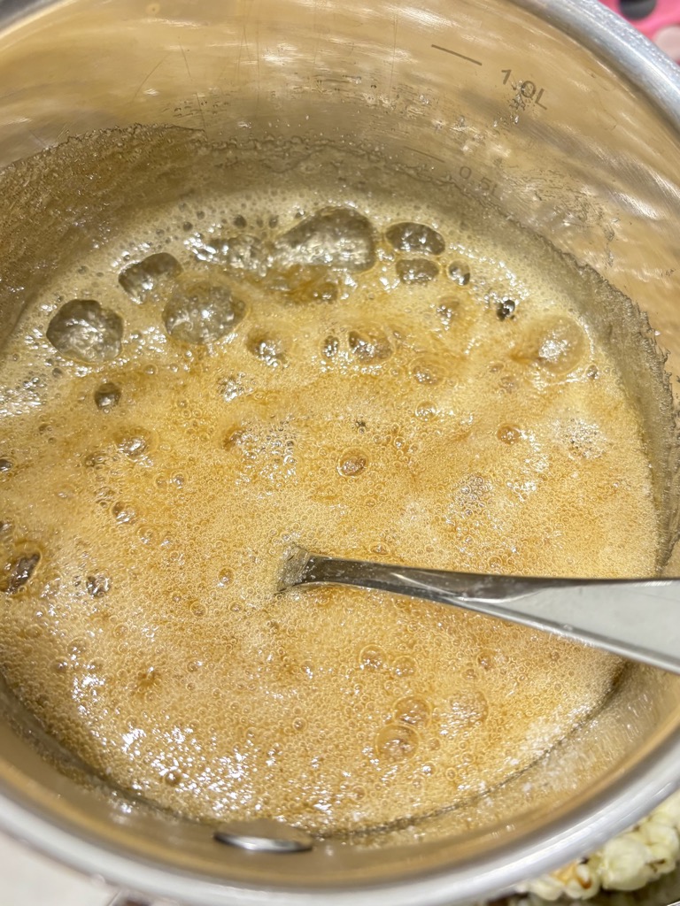 Vegan caramel sauce bubbling in metal pot