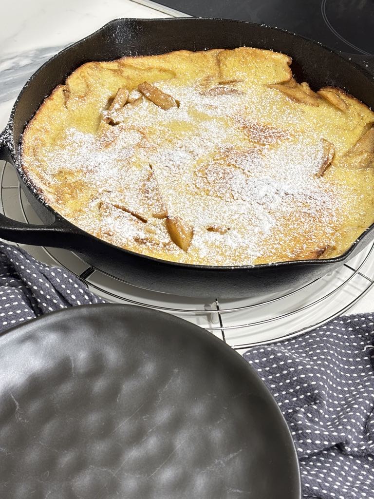 Traditional German apple pancake baked in cast iron, topped with powdered sugar for a simple, old-school breakfast or Christmas morning treat.