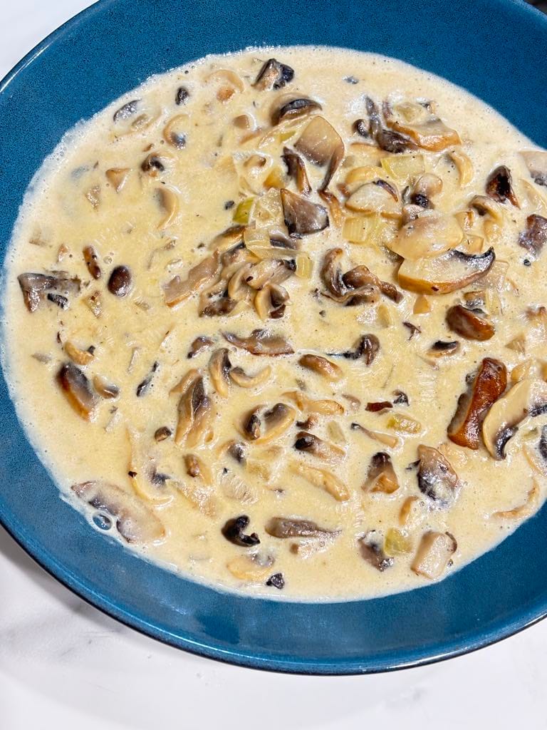 A rich and velvety simple sauce made with cremini mushrooms, onion, butter, and heavy cream, freshly cooked in a small saucepan. Perfect for spooning over pork chops, pasta, or spaetzle.