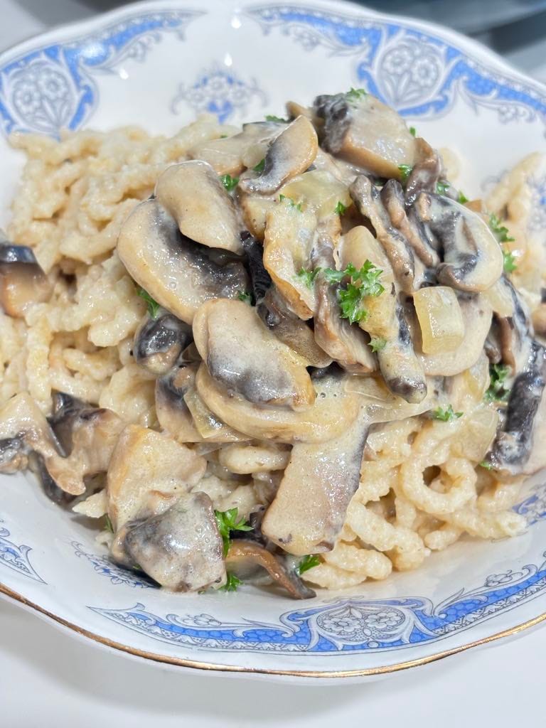 Creamy mushroom sauce clinging to tender spaetzle noodles, made with butter, broth, and heavy cream for a rich and silky texture.