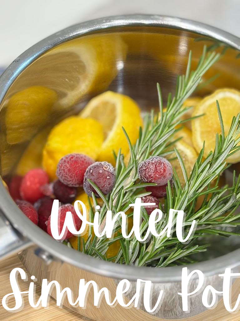Easy homemade simmer pot with lemon, cranberries, and rosemary creating a natural, festive home fragrance.