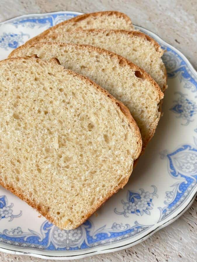 Detailed view of sliced white sandwich bread highlighting the soft interior crumb and lightly browned crust.