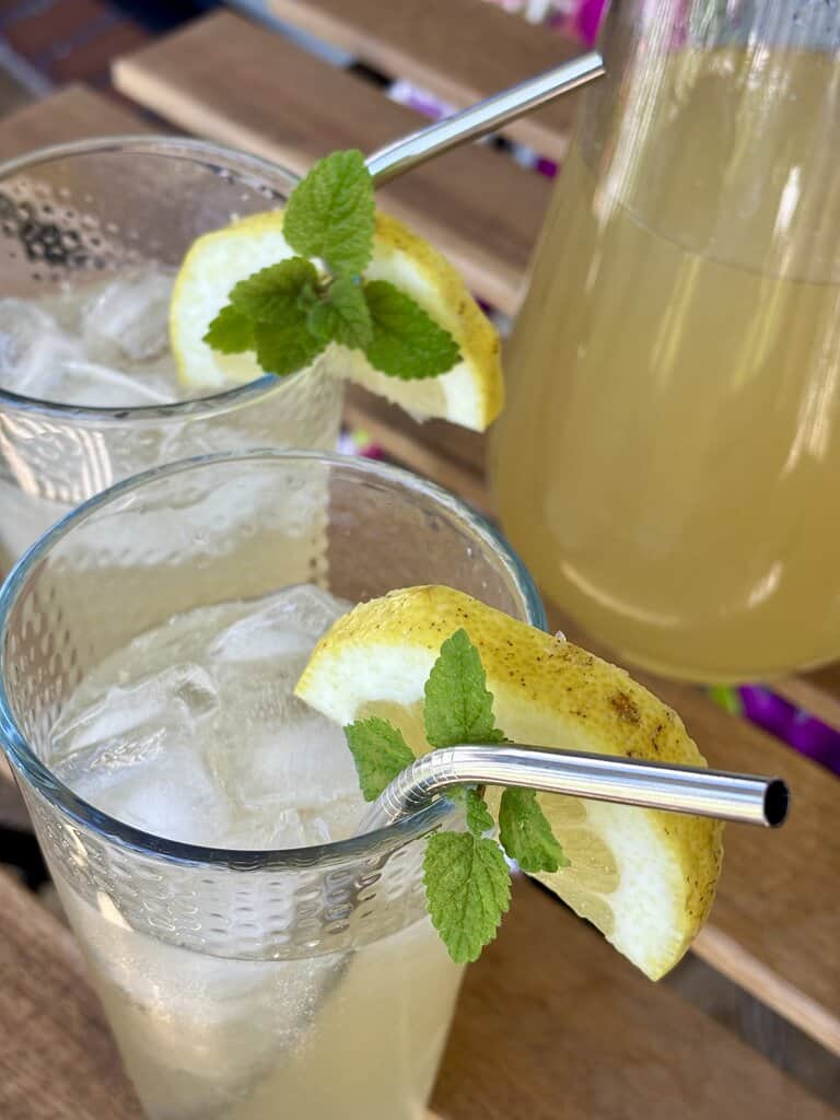 Easy old-fashioned lemonade recipe made with fresh lemons and simple ingredients, styled on a rustic wooden table.